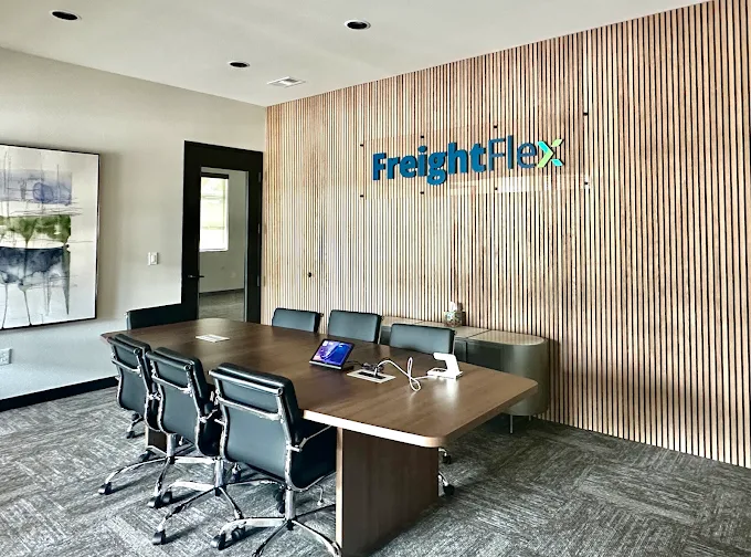 Freight Flex conference room with the company logo displayed on the wall
